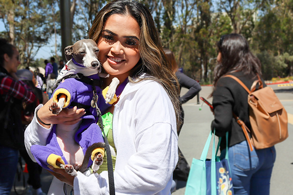 a student holding a stress-buster dog in Mental Health Awareness Month