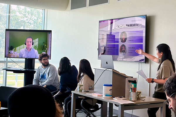 Conference panel speakers presenting with screen