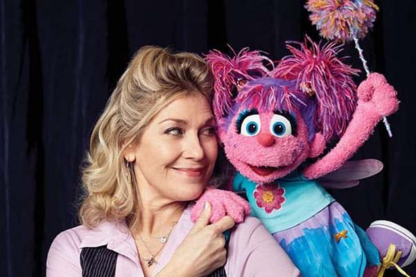 Leslie Carrara-Rudolph with Sesame Street character Abby Cadabby, a pink puppet