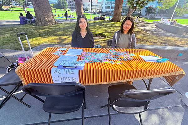 Active listening table place at quad with 2 representatives waiting