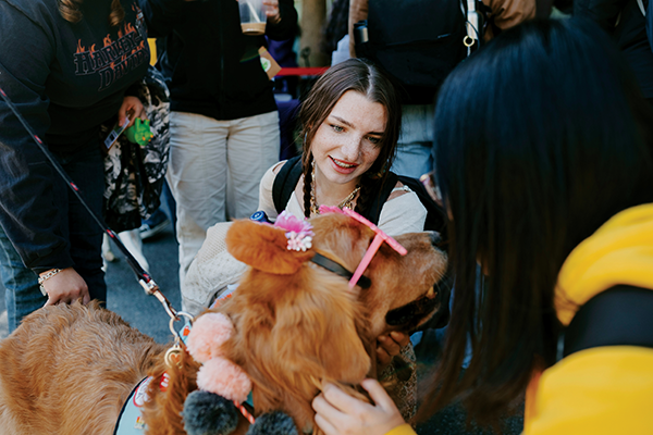 Student destressing with therapy dogs