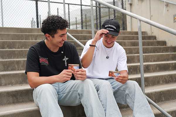 2 students sitting on stairs