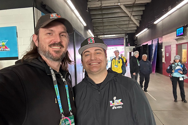 Graham Carpenter and Julian Riga pose together at Levi’s Stadium during Super Bowl LX.