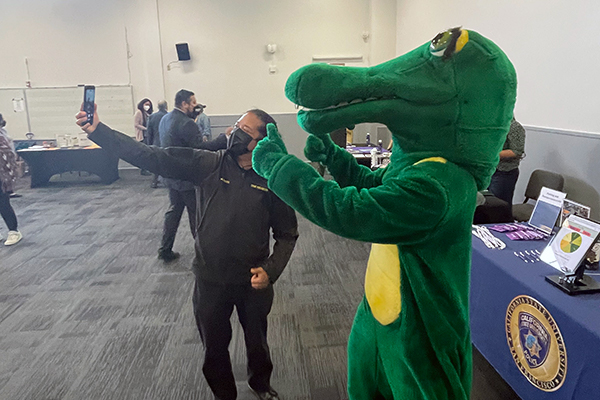 a staff member taking a 'selfie' with Ali Gator