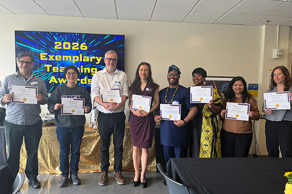 Exemplary Teaching award winners holding up their award certificates