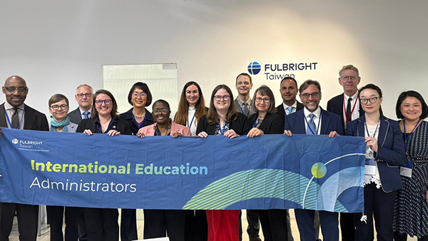 Fullbright scholars holding up banner