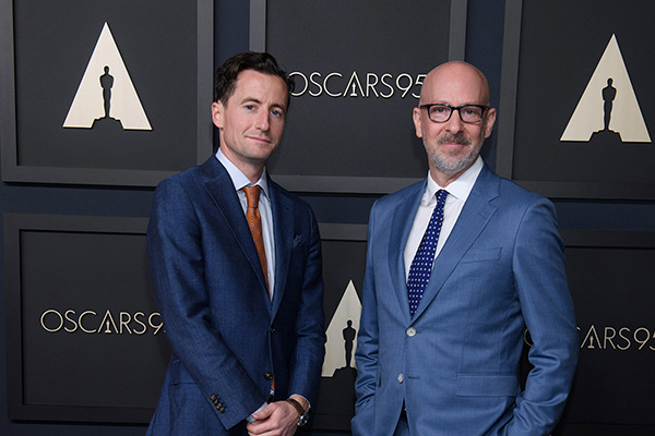 Conall Jones and Joshua Seftel pose together on the 95th Academy Awards red carpet