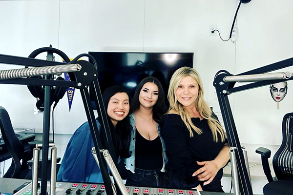 Three students stand in new state-of-the-art studio