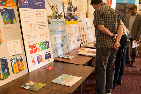 People browse posters and materials at a research tabling event.