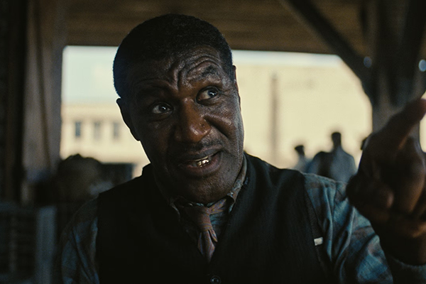 Screen capture from Sinners featuring Delroy Lindo as Delta Slim in dialogue.