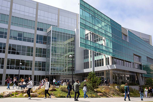 students walking across the library