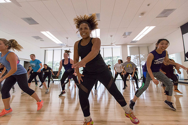 View from the front of the studio showing a group of people participating in an exercise class at the Mashouf Wellness Center.