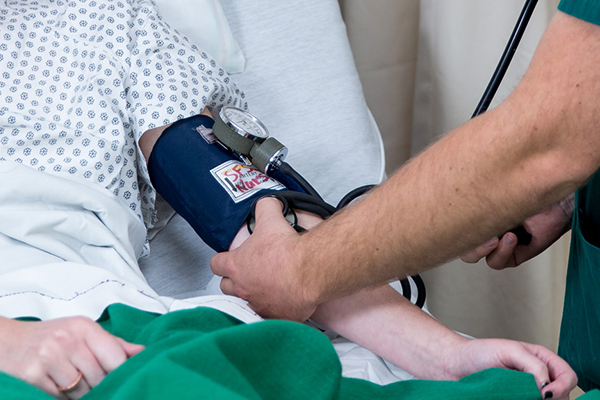 a patient getting their blood pressure checked