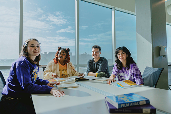 Group of 4 students seated at a table
