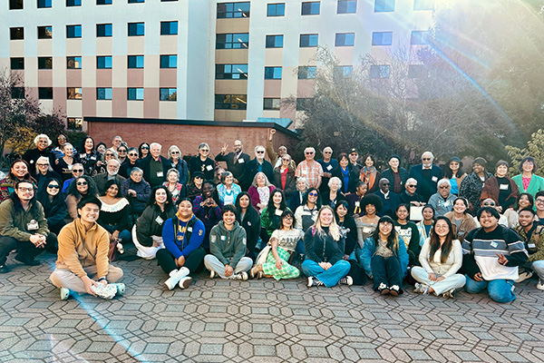 A group of students, faculty, staff, and members of the original 1968 SFSU Black Student Union–Third World Liberation Front student-led strike pose together.
