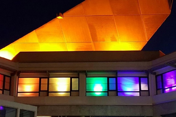 SFSU Cesar Chavez building lit up in rainbow colors to signal safe zone