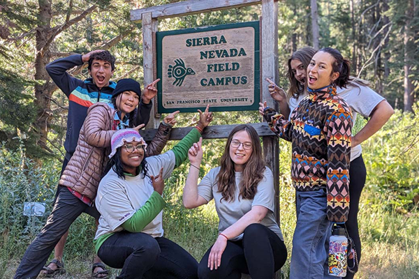 Students pose with the Sierra Nevada Field Campus sign