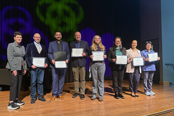 SFSU staff recognized for their years of service holding their certificates