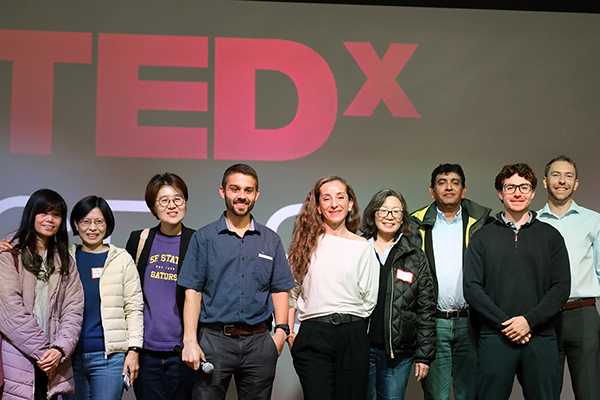 SFSU business student volunteers and organizers stand on the TEDxSF State stage.