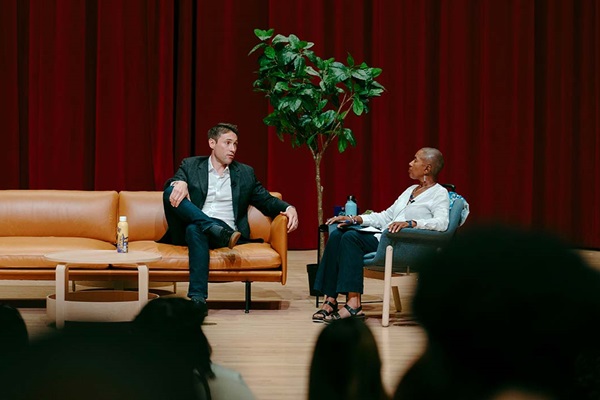 Whit Johnson and Venise Wagner chat on a couch