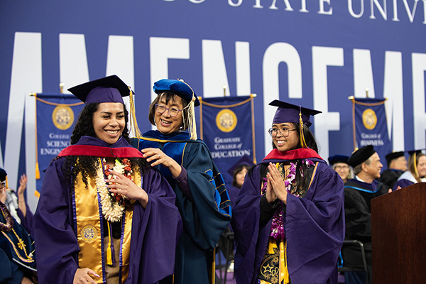 SFSU Hood Graduates receiving their special sash
